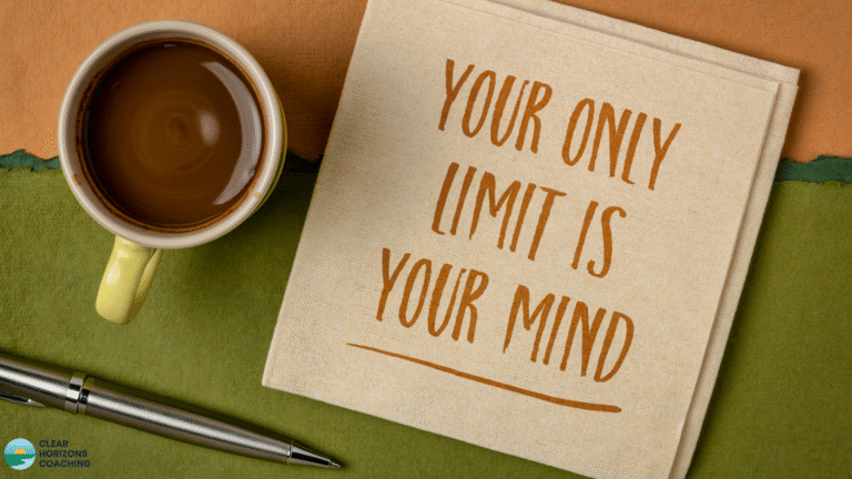 Image is a coffee cup, pen and square note card seen from above. The note card says "Your Only Limit Is Your Mind"