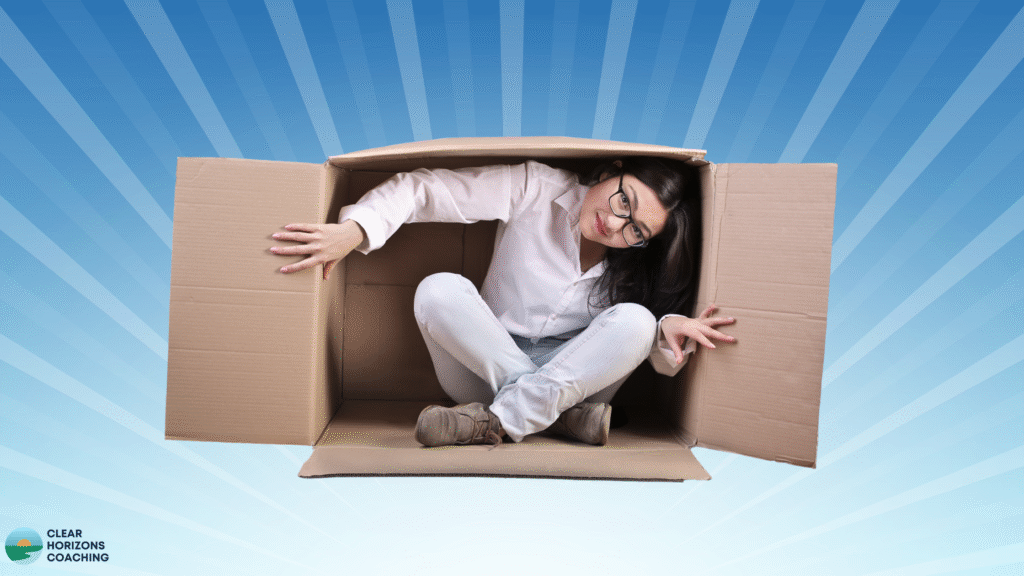 Image is of woman in a cardboard box turned on it's side. The box is open and the woman is climbing out. The background is blue with radiating white lines.